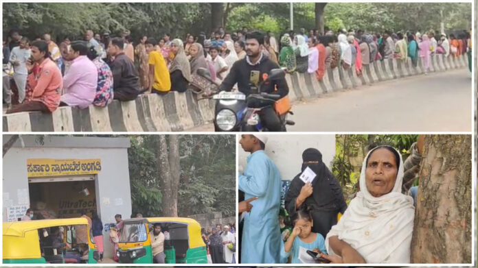 People queue up in front of the fair price shop for ration card correction